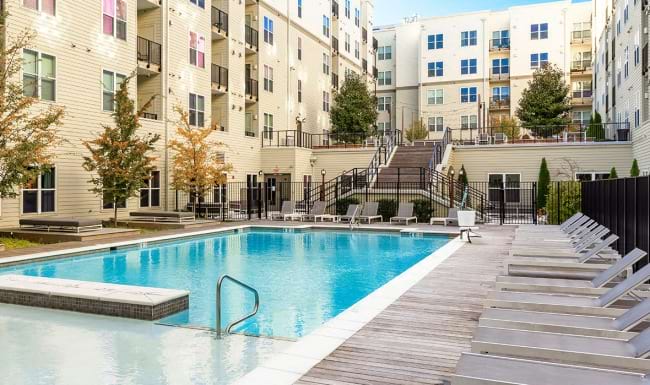 pool showing reclining seating and nearness to property buildings