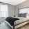bedroom with a large window and modern decor